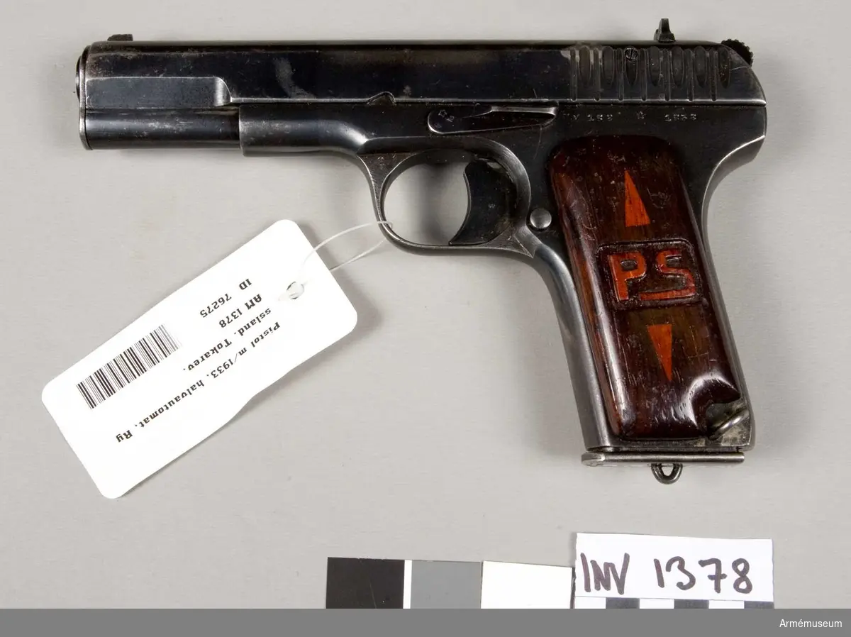 Halvautomatisk pistol. Kolvkapporna av trä märkt med "PS". Magasinets tillv.nr: M 162.