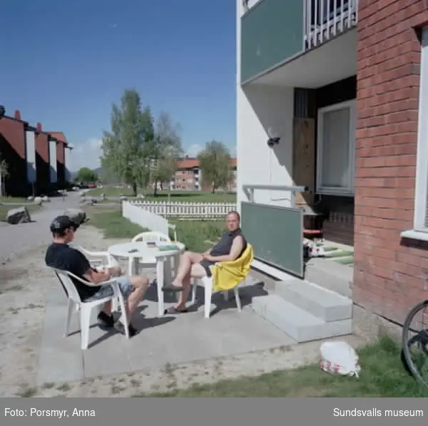 Dokumentation av Mitthems renovering, Kvarteret Vetet. Bild på bostadsområdet på Hårdvallsgatan samt människor som spelar boule.