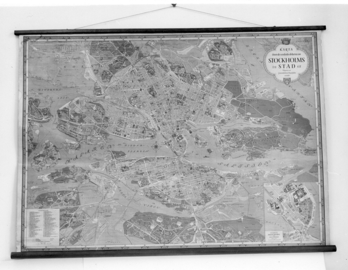 Stadskarta över Stockholm från år 1948, med en
inflikaddetaljkarta över Gamla Stan. Kartan tryckt på papper på väv.
Påkartans långsidor är träribbor fästade. Vid den övre är ett
snörefäst, för upphängning på vägg.