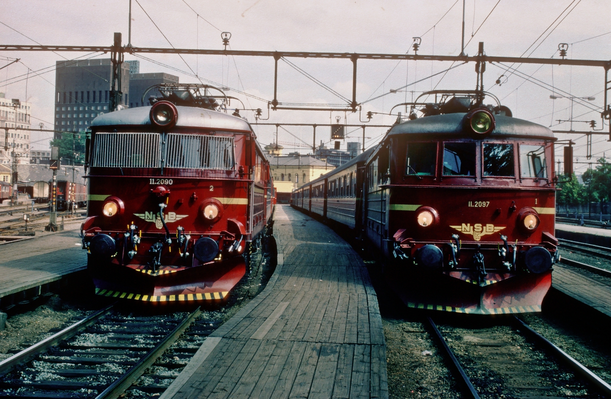 To persontog på Oslo Vestbanestasjon trukket av NSB elektrisk lokomotiv El 11 2090 og 2097.