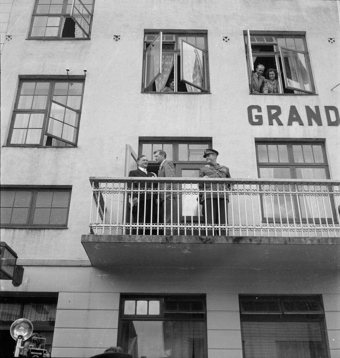 Kronprins Olav og to andre menn på balkongen på Grand Hotell i Egersund.