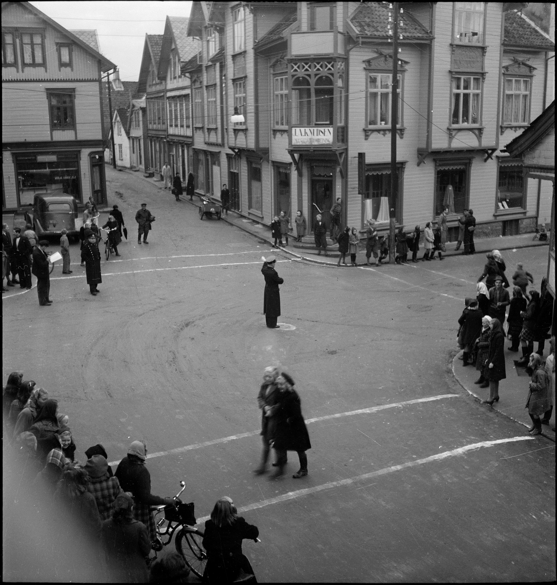 Trafikkuka i Egersund, 10.-16. november 1947. En konstabel dirigerer trafikken, og det arrangeres et sykkelrenn.