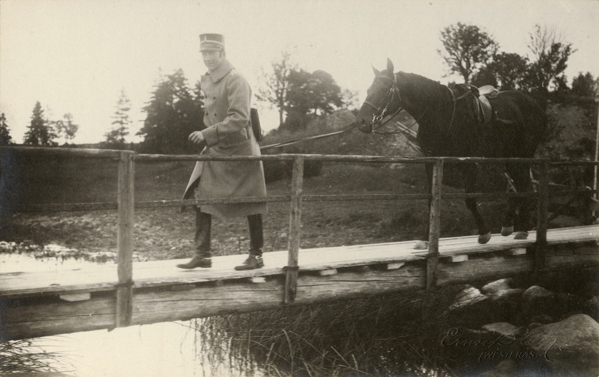 Soldat leder hästen över en bro.