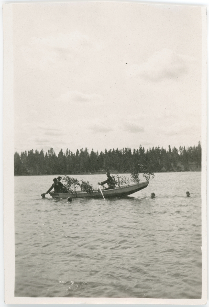 Män i lövad roddbåt, Uppsala