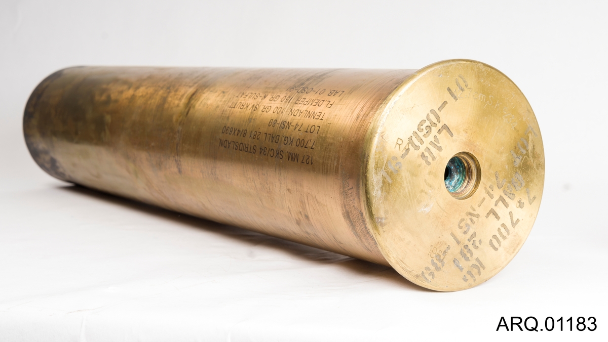 Messinghylse for granat av typen 12,7 cm SKC/34. Hylsen har stempel RA og er trolig laget ved Raufoss ammunisjonsfabrikk. Ser ut til at de malte opplysningene forteller at den har vært brukt senere (mellom 1989 og 1991).