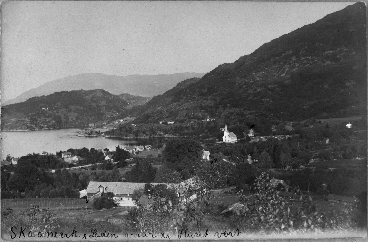 Postkort med landskapsmotiv frå Skånevik sett mot nordaust, 1936. I forgrunnen er garden Milja. Midt i biletet er Skånevik kyrkje.