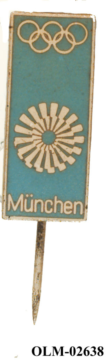 Merke med nål og emblemet til de olympiske sommerleker i München i 1972. Det er også motiv av de olympiske ringene.