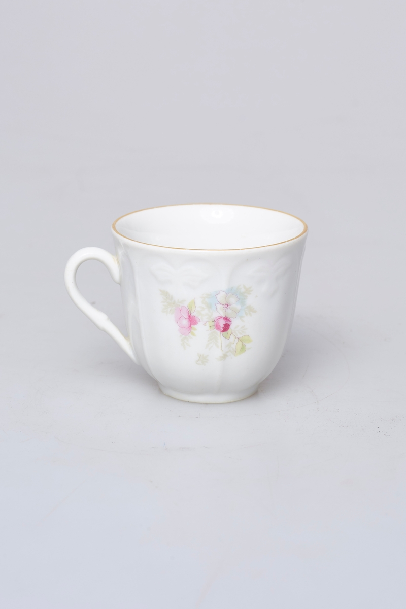 Kaffekopp (b) og skål (a). Hvit med rosa, grønt og lyseblå dekor. Den har gullkant og et rosemotiv på hver side. Skålen har mønstret gullkant og to rosemotiv.