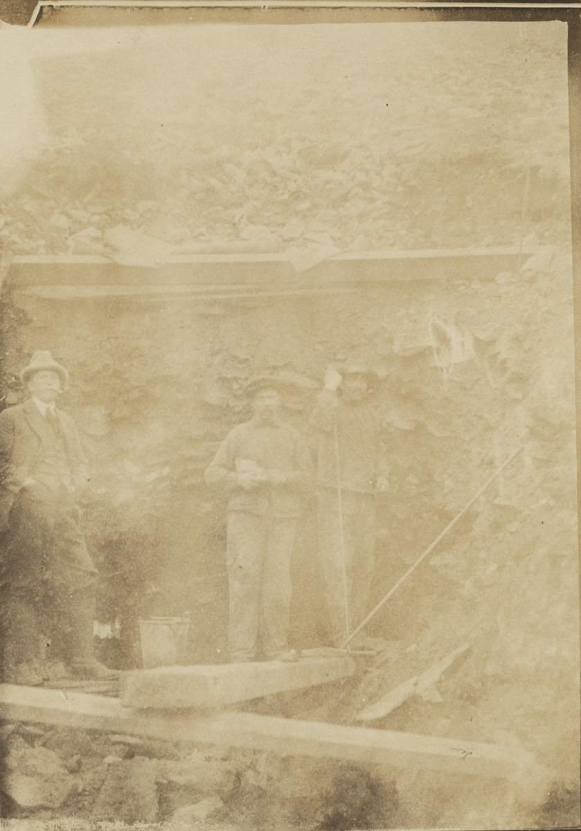 Fotografi från expedition till Spetsbergen 1920. Motiv av tre män vid ingång till gruva.