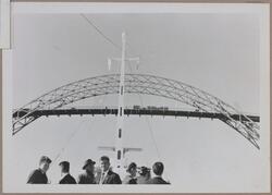 En gruppe menn titter opp på Karmsund bro fra et dekk, antag