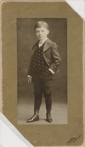 Portrett av en liten gutt i penklær.