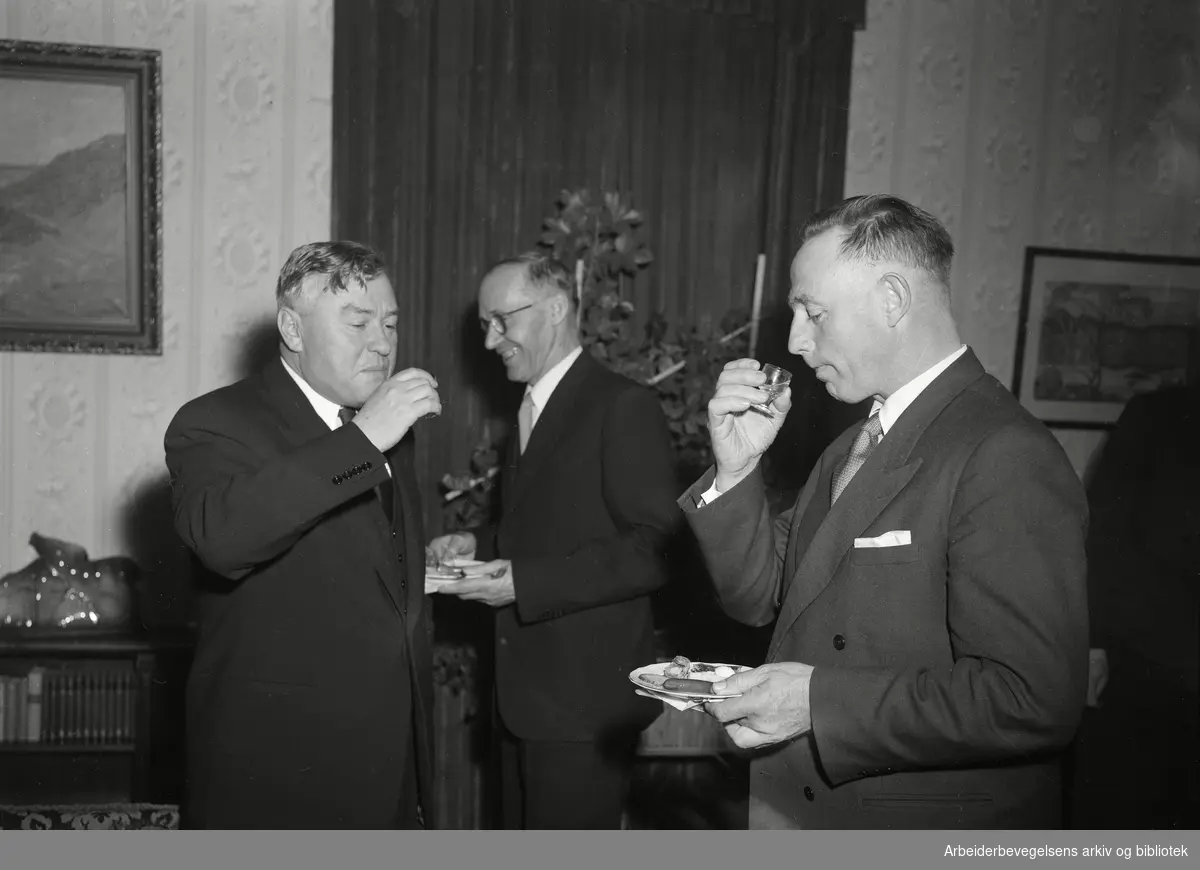 Stortinget er invitert på kaviar og vodka i den sovjetrussiske ambassaden. Ambassadør Georgij Arkadjev (til venstre) og to norske stortingsrepresentanter. 21. April 1955.