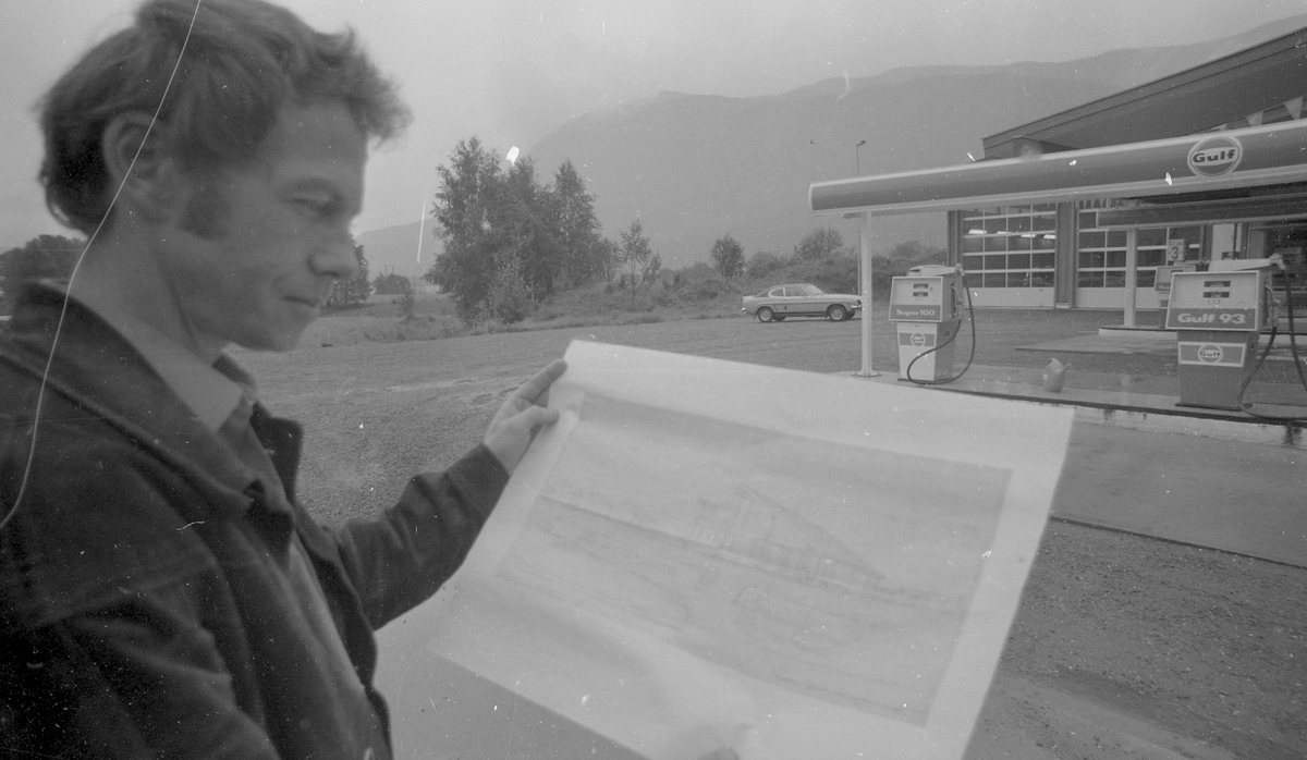 Portrett
Svein Fyen foran Gulf stasjonen (nå Shell) ved Rv 7. Han viser fram tegninger av et motorhotell.
