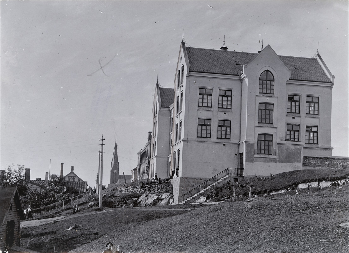 Det gamle og det nye bygget på Breidablikk skole, Haugesund. I bakgrunnen er spiret på Vår Frelser kirke.