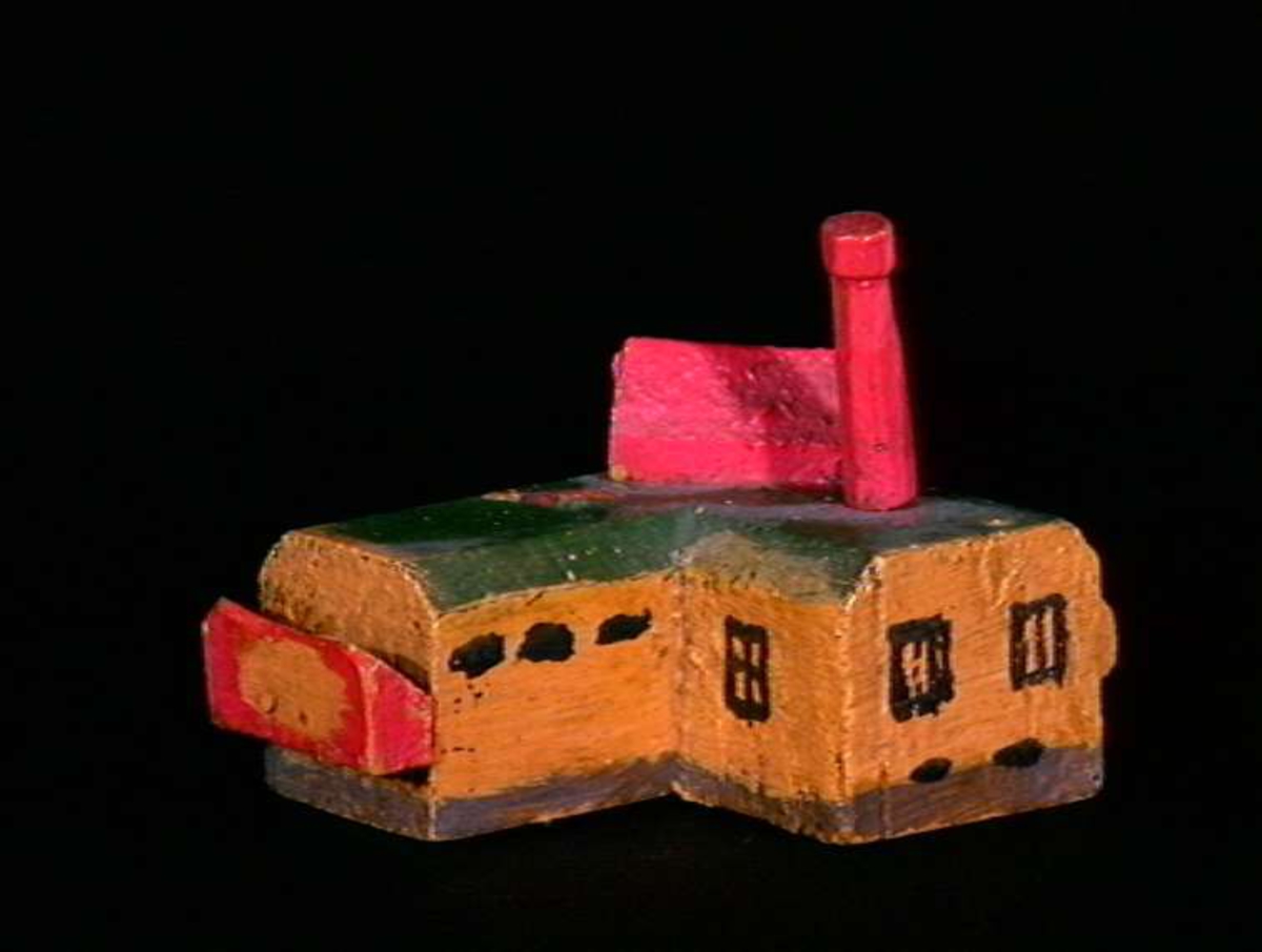 Sett med ca 200 leketøyhus laget av tre i forskjellige former og farger.