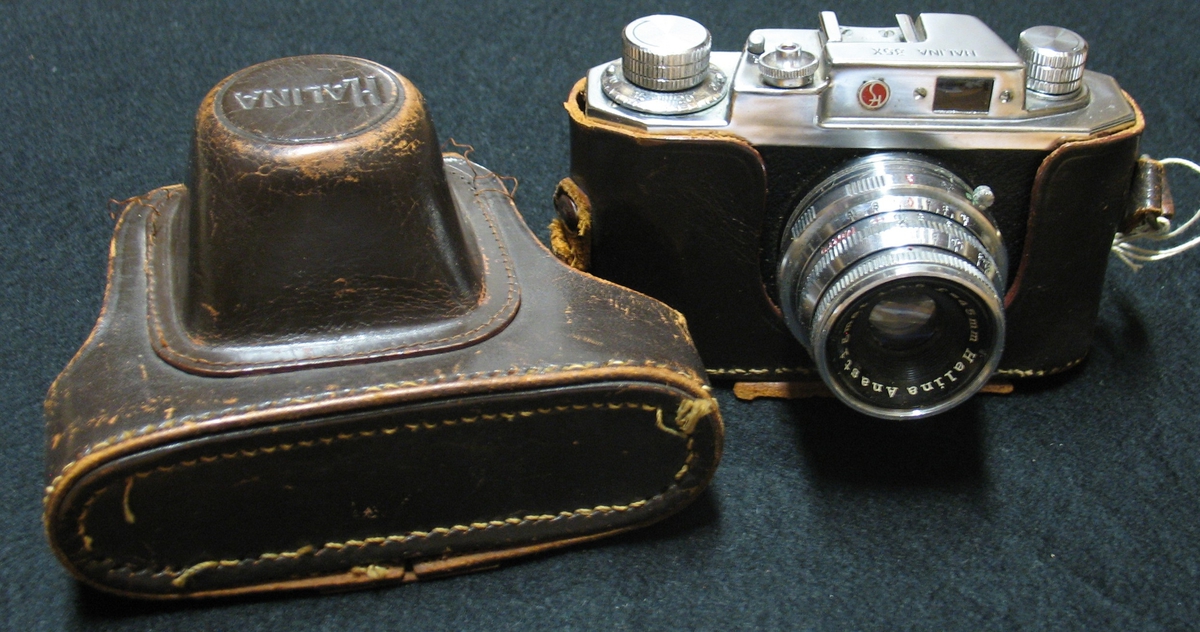 En småbildskamera i brunt läderfodral. Objektiv halina anastigmat 1:3,5, f= 45 mm.