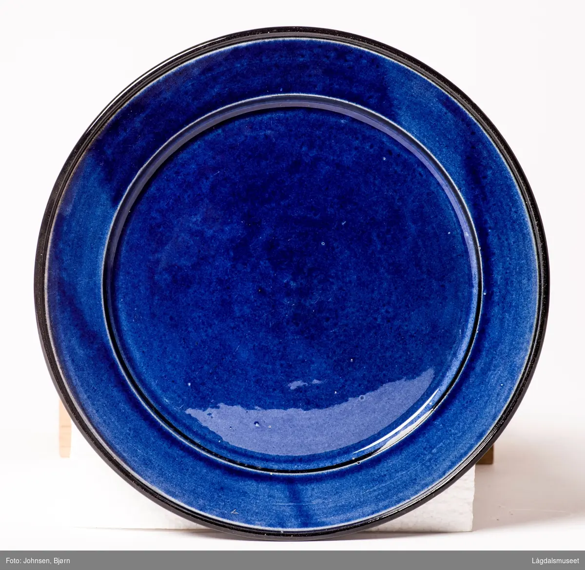 Koboltblå kopp uten dekor, svart under og blå oppå.