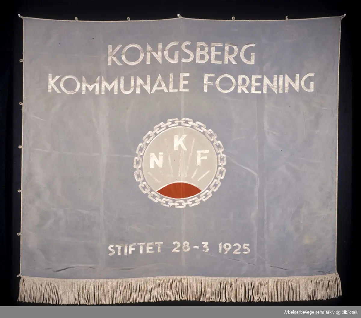 Kongsberg kommunale forening.Stiftet 28. mars 1925..Forside..Fanetekst: Kongsberg kommunale forening.Stiftet 28. mars 1925