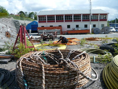 Kabelkveiler og tromler utenfor sjøkabellageret (Foto/Photo)