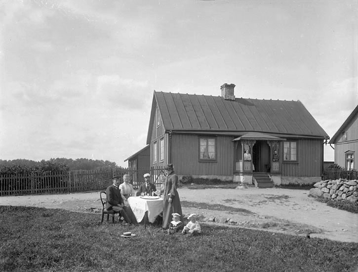 Elias Fredrik Gustafsson med familj framför sitt bostadshus i Älmhult, ca 1910.