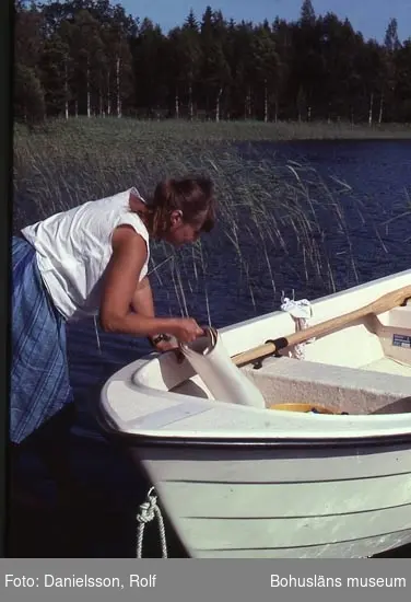 Antikvarie Kerstin Olsson med en kartrulle vid en båt på Kynnefjäll