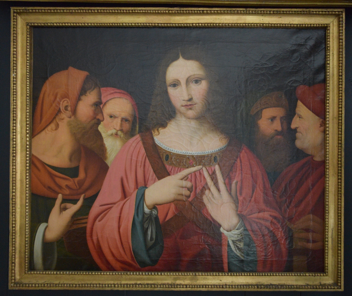 Bildet viser Jesus kledd i rød kjortel i diskusjon med de skriftlærde. Gesten han gjør kan være telling av argumenter på fingrene,  det er kjent at dette var en hukommelsesteknikk også i antikken. Jesus er omgitt av to lærde på hver side. Bakgrunnen er mørk. På venstre side går ikke motivet helt ut til kanten, men ender i en bråbrun kant. 

Maleriet er en kopi av av et bild eav Leonardo da Vinci, men det er lite trolig at det er en direkte kopi. National gallery i London har en Leonardo-kopi utført avLuini, og denne har temmelig nøyaktig de samme målene osm det aktuelle maleriet på Gimle. Det er trolig at bildet derfor kan være en kopi av det malt av Luini. i forhold til Leonardos original er maleriet en temmelig god gjengivelse også i detaljer. Imidlertid virker Jesus' ansikt en smule mer feminint på kopien. 
Det originale Leonardo-bildet ble bestilt av Isabel D'Erste 14. mai 1540, og var ferdig omkring 1507.