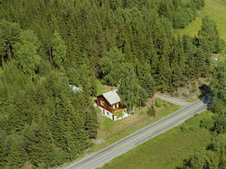 Sør-Fron, Harpefoss. Rødbrunt bolighus i tømmer langs E6.