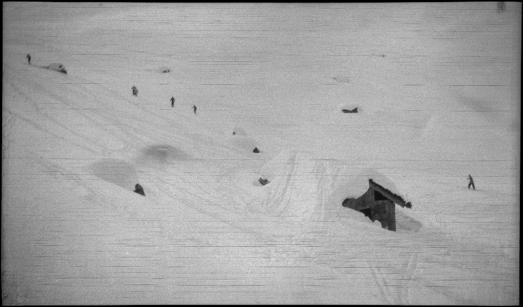 En guttegjeng på skitur i fjellene ovenfor Saudasjøen. Det er bilder av gjengen som går oppover bakkene, og fra en pause ved en gammel hytte.