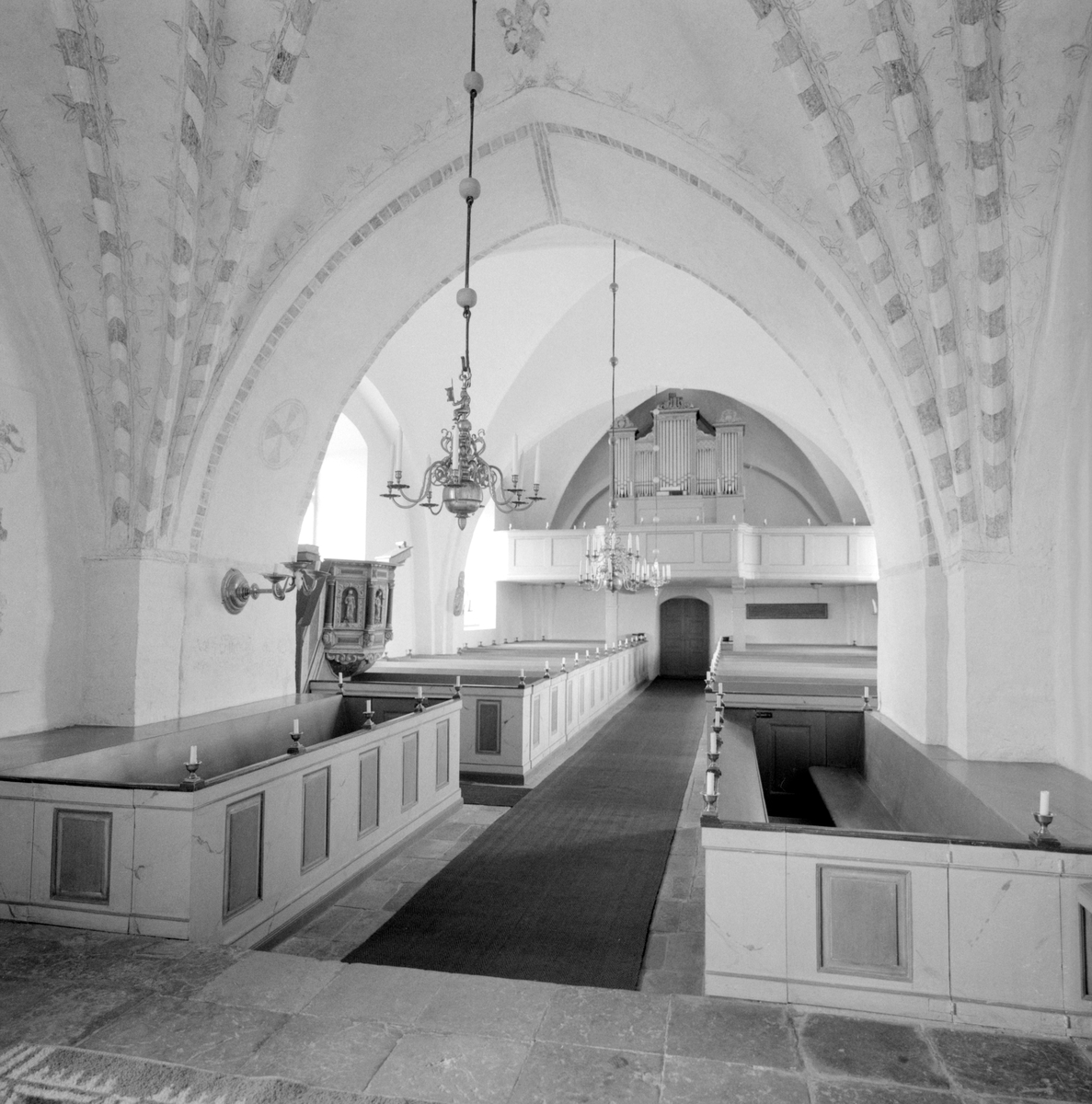 Interiör av Tingstad kyrka. I det medeltida långhuset ses tydligt senare tillägg i bänkinredningen från 1860 och orgeln invigd 1862. Den sistnämnda är byggd av den kände orgelbyggaren Sven Nordström.