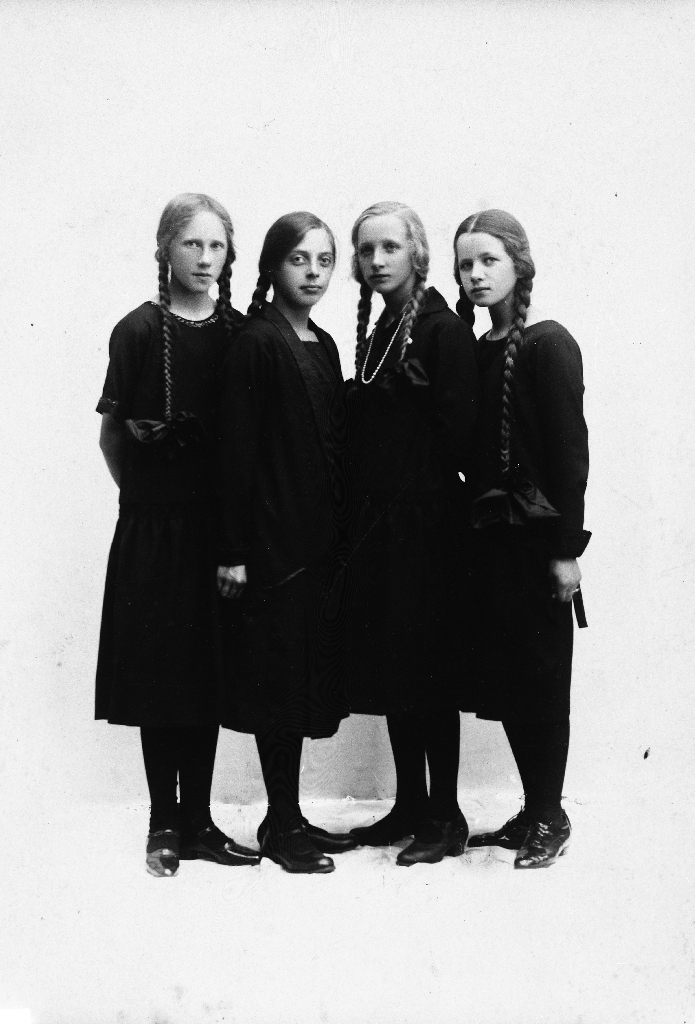 Fire jenter med fletter som gjekk i same klasse. Konfirmantar?. Frå v. Anna Time, Marit Hadland, Jofrid Fotland og Randi Time.