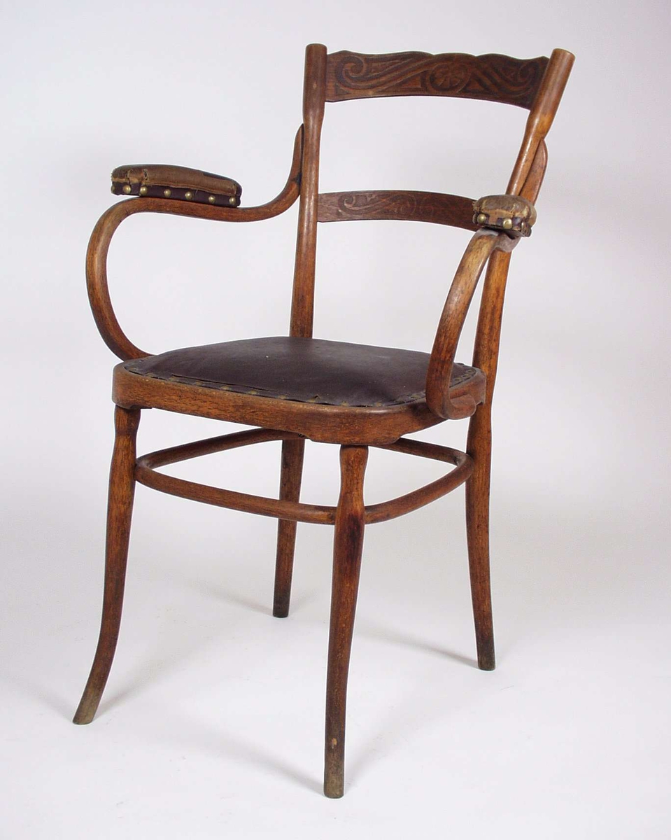 Stolene er av bøk med mønster presset på i ryggen. Trekket er naglet fast til sete, rygg og armlener.