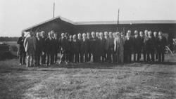 Gruppe med velkledde, middelaldrende menn.