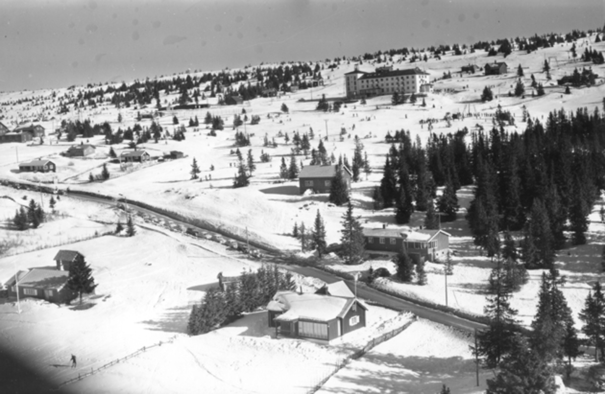 Flyfoto av bebyggelse i vinterlandskap på Sjusjøen, Ringsaker Almenning.