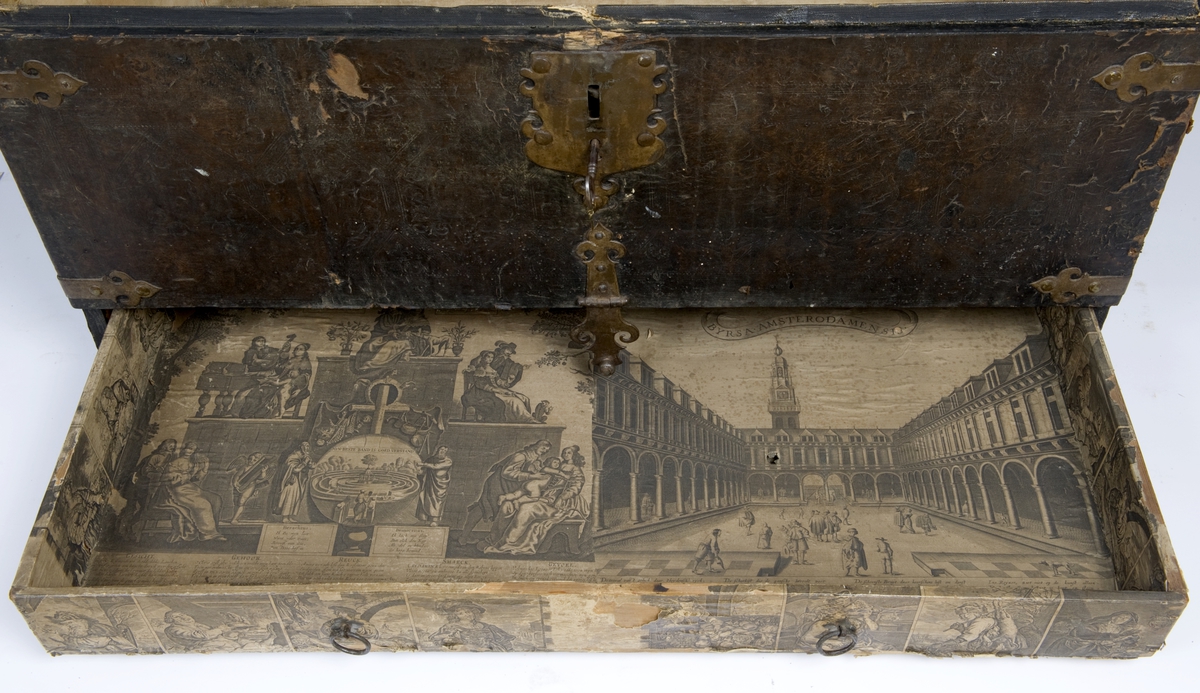 Kiste med buet lokk. Trukket med preget lær utvendig. Innvendig foret med tekstik. I fronten en låsbar skuff foret med kobberstikk med datering "Decem 1651"