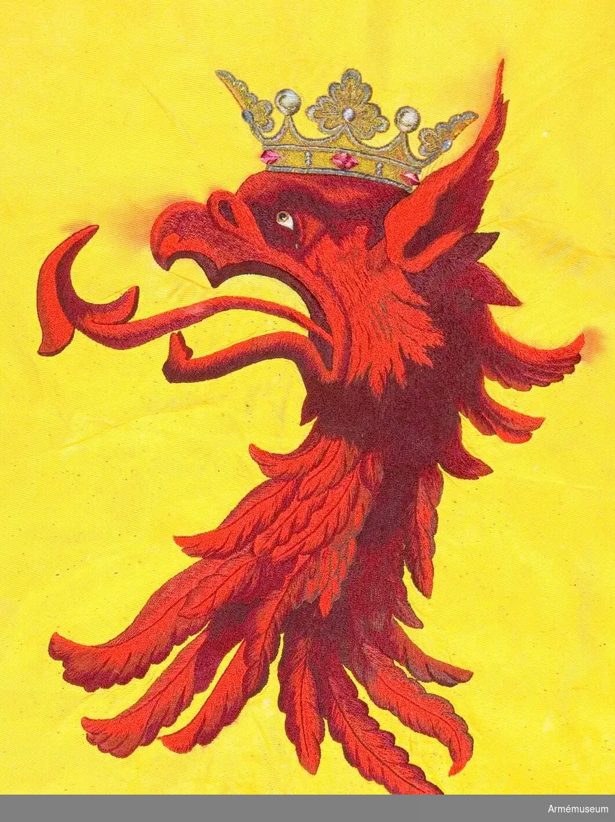 Grupp B.

En sida av ett dubbelsidigt standar, gult 4-skaftat fansiden med emblem: Skånes vapen krönt griphuvud, röd schattersöm med krona i guldbroderi med stenar i röd schattersöm. Därunder segernamnen POSEN 1704, FRAUENSTADT 1706 i guld.