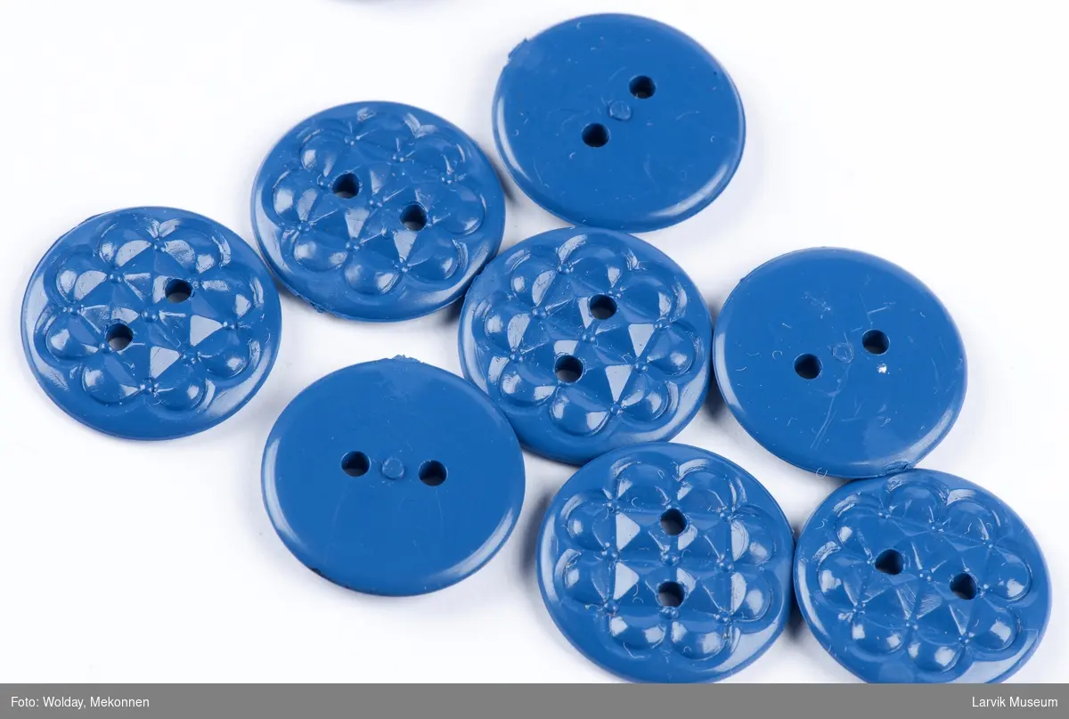 Uttallige knapper i en pappeske m/lokk. En knapp montert på utsiden av lokket