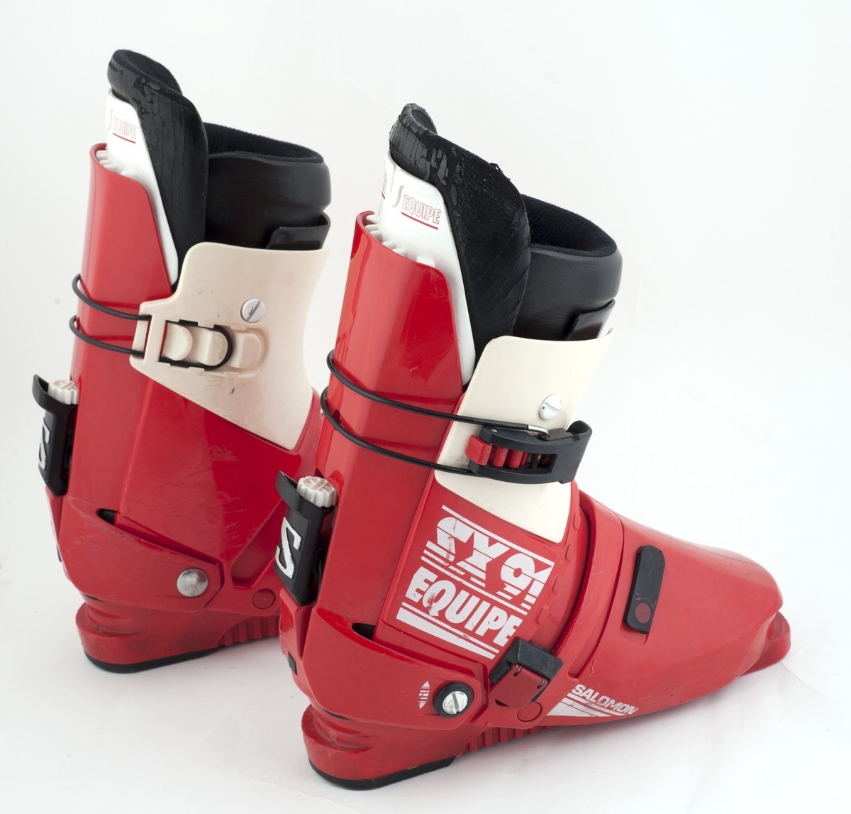 Et par røde Salomon slalomstøvler med hvite og svarte detaljer.