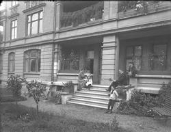 Familiebilde, mor, far og tre barn på hagetrapp