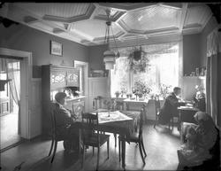 Familiebilde, mor, far og ett barn i spisestue