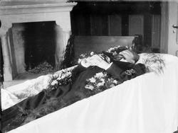 Begravelse, mann i kiste, blomster,interiør