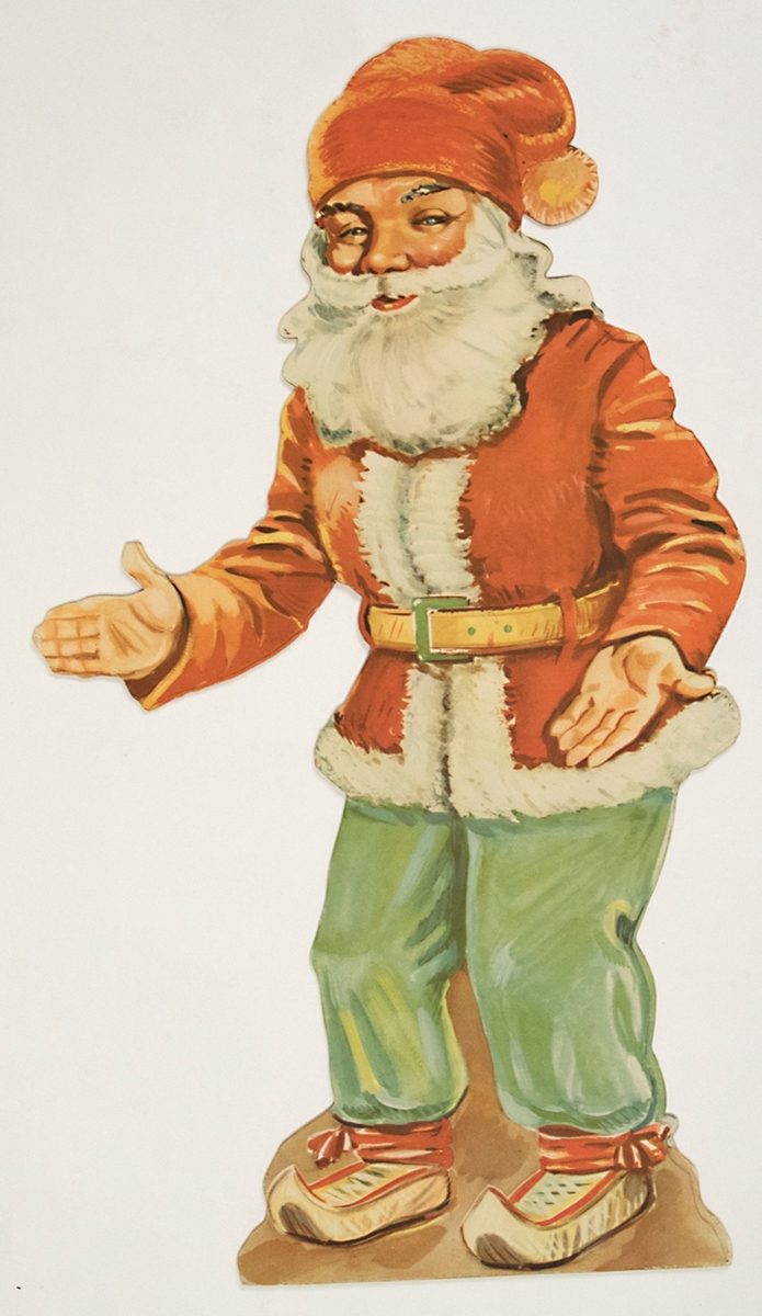 Julprydnad av papp, konturskuren i form av en stående jultomte med polykromt tryck på framsidan. Stöd av vikbar pappskiva på baksidan. Tomten är klädd i röd luva, röd jacka med vit kantning, gröna byxor och näbbskor, samt bär skägg.