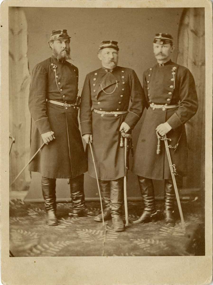Porträtt av David Fabian Gustaf Adolf Ohlson (mitten), major vid Jönköpings regemente I 12. Omgiven av två okända officerare.
Se även AMA.0008213, AMA.0008219, AMA.0008223 och AMA.0008228.

Gustaf Adolf Ohlson är känd som uppfinnare av olletröjan.