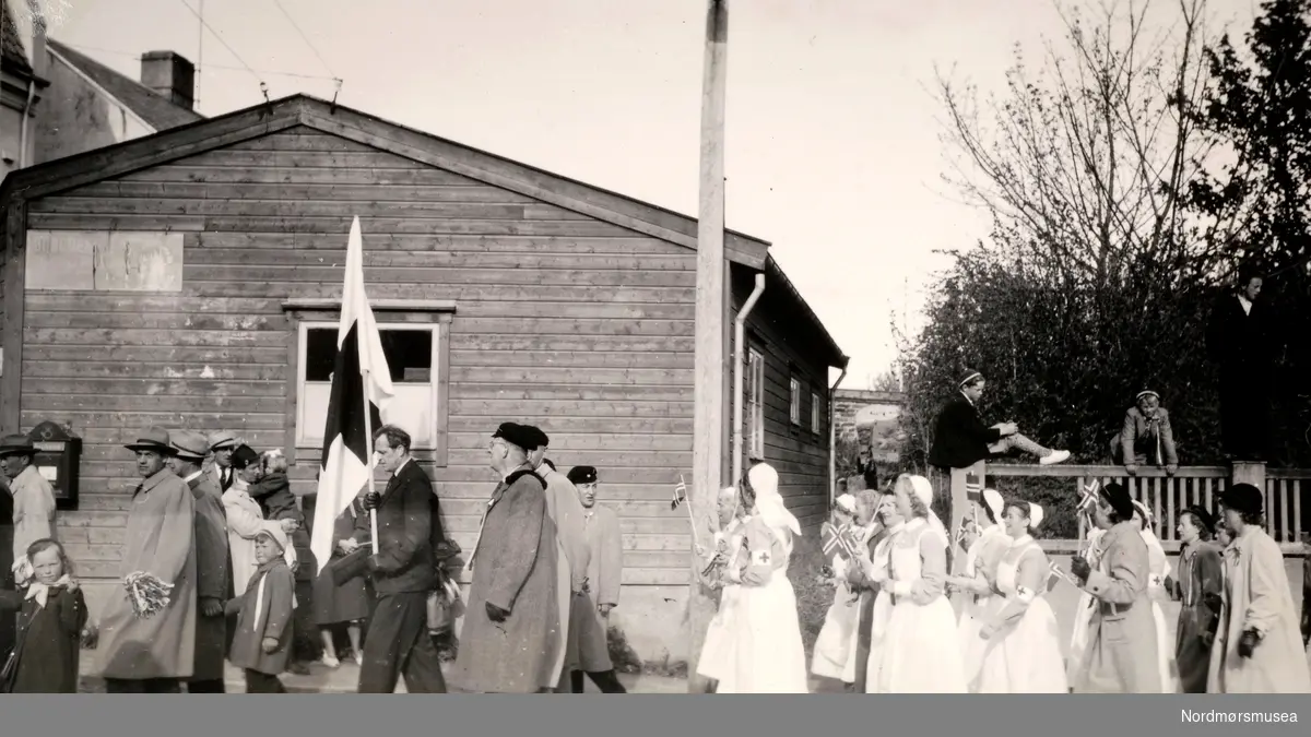 Foto fra 17. mai 1946, trolig ved Røde Kors' søsterhjem i Oslo. Legg merke til flagget i front av opptoget. Fra Ida M. Knudtzons fotosamlinger, nå en del av Nordmøre Museums fotosamlinger.