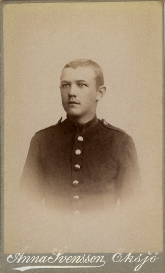 Porträtt (bröstbild, halvprofil) av en okänd ung man, klädd i 
beväringsuniform.