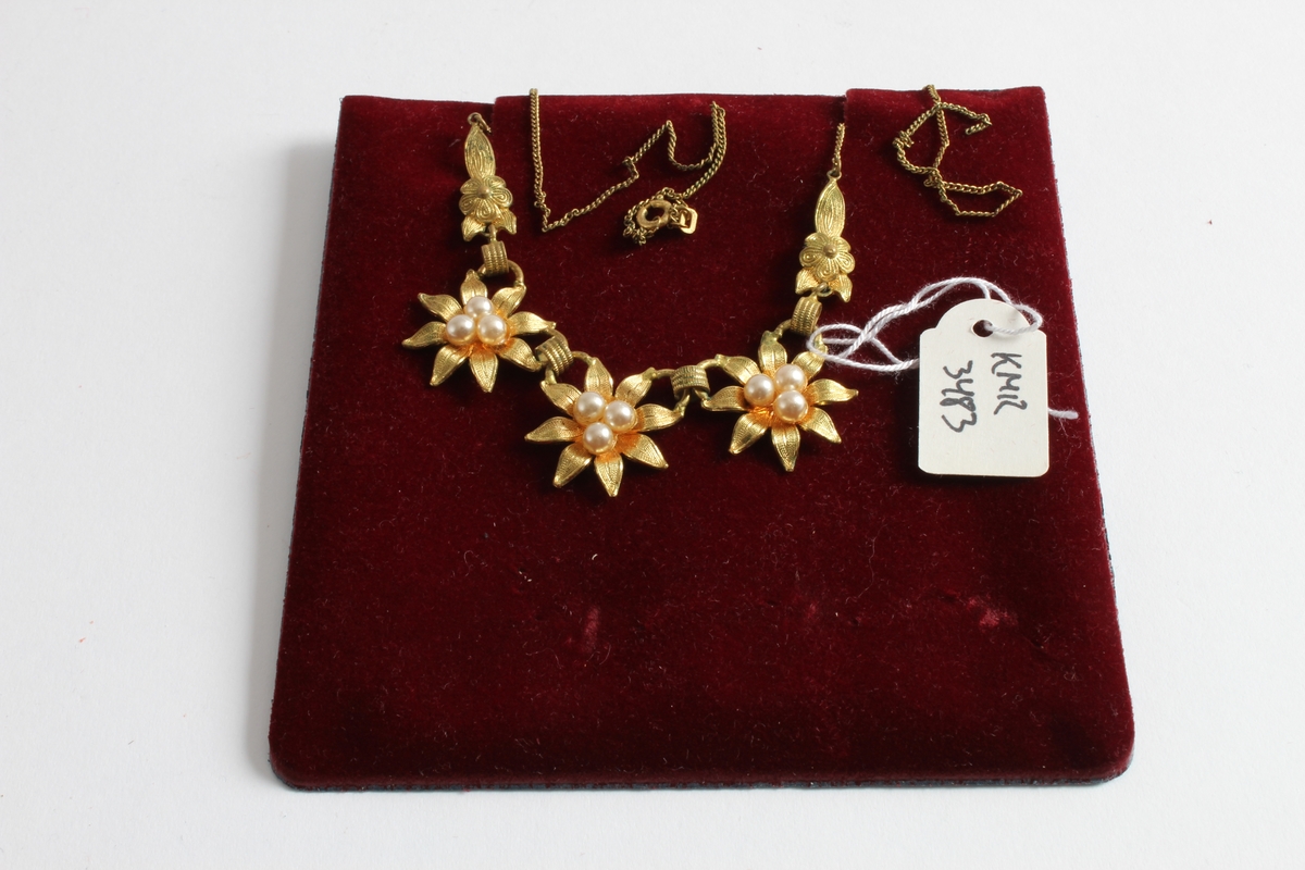 Gitt av Torill Lerdalen Hùser (f.1946).

Et collie-smykke fra ca 1950 med perler. Smykket er gullfarget og i metall, bestående av 3 blomster som hver har 3 perler. Et defekt kjede.