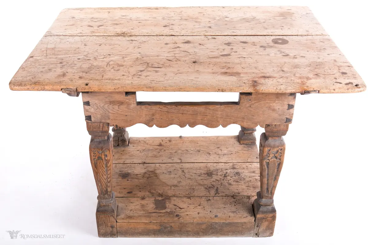 Platen hviler på arkitrav som igjen hviler på koniske pillarer med en form for kannelering med kapitel/terningkapitel og basis. Alt hviler på postamentet med høyde 12 cm.