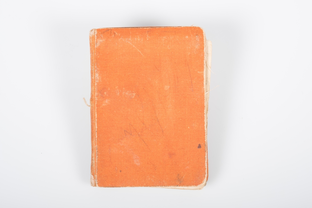 Minnebok i orange kunstskinn. Boken har hilsner, adresser, tegninger/akvareller.