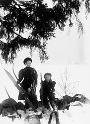 To unge, kvinnelige skiløpere, fotografert mens de kvilte på