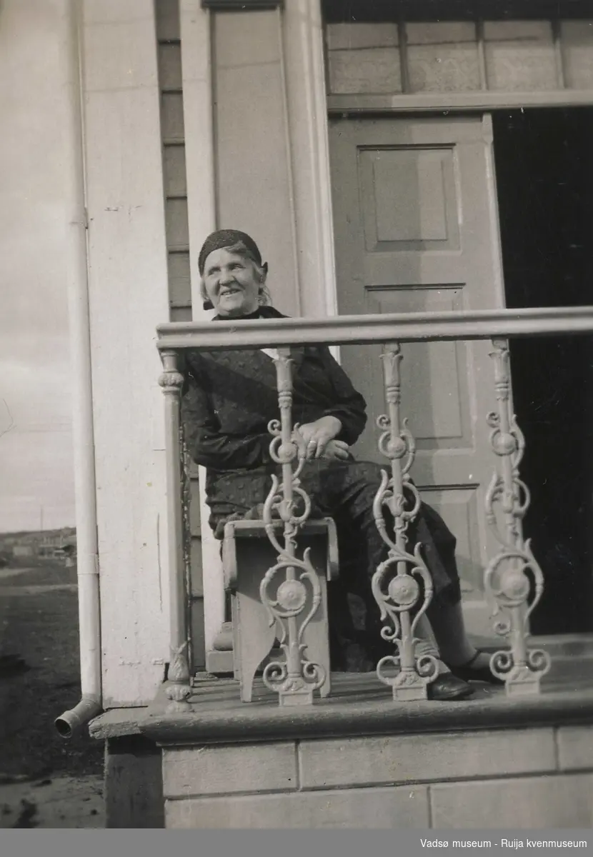 Ma Esbensen på benk foran inngangen til Esbensengården i 1933.