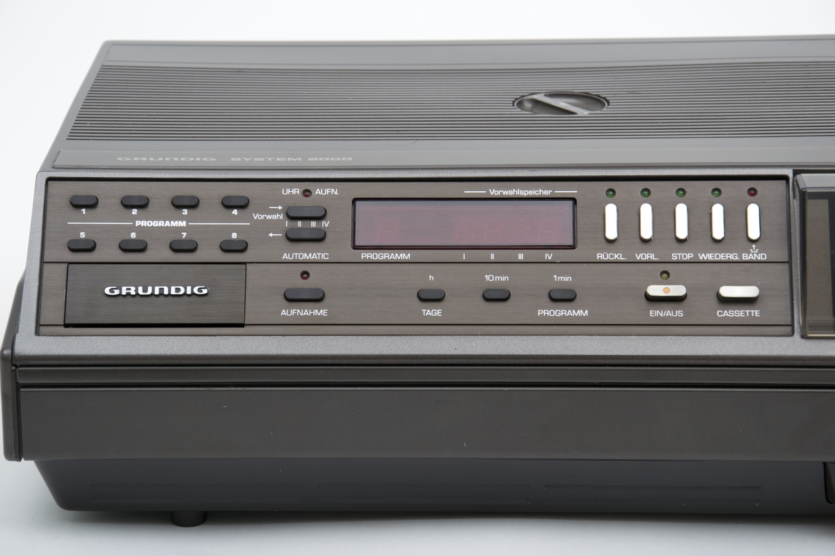 Videospiller, Grundigs analoge hjemmevideospiller "Video 2X4-plus" i formatet V2000 ble lansert i 1981, som en utbedret versjon av den opprinnelige 2X4 som kom i 1980, med tilleggsfunksjonen rask spoling, stillbilder og slowmotion. 
Grundigs (og Philips) V2000 (videoformat)system ble utkonkurrert av VHS- og Betamax-systemet, men er av mange oppfattet som et bedre filmvisningsprodukt enn disse. Kan ha blitt produsert fram til 1988.
Kassetene kunne avspilles på begge sider.
Kassethuset ligger på høyre side og lukkes med et pleksiglasslokk og under dette ligger de nye funksjonsknappene. Øvrige funksjonsknapper ligger på venstre siden for kassethuset.